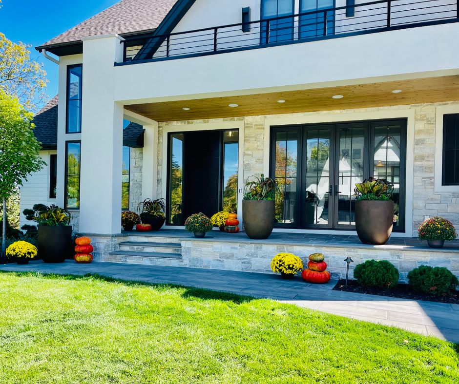 Modern house exterior with decorative elements and a well-maintained lawn.